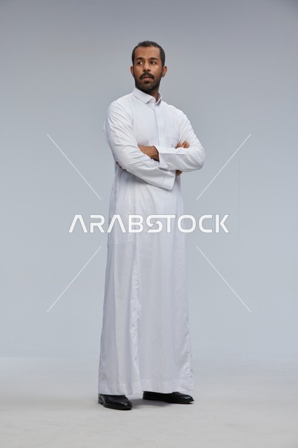 Saudi Man in White Thobe with Arms Crossed