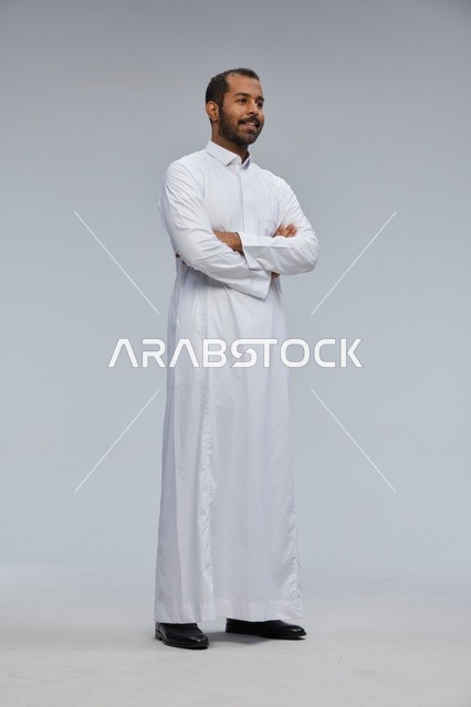 Saudi Man in White Thobe with Crossed Arms in Studio