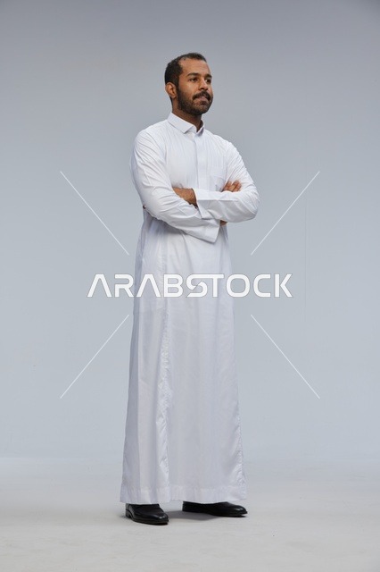 Saudi Man in White Thobe with Crossed Arms Studio Shot