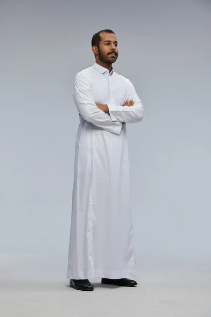 Saudi Man in White Thobe with Crossed Arms Studio Shot
