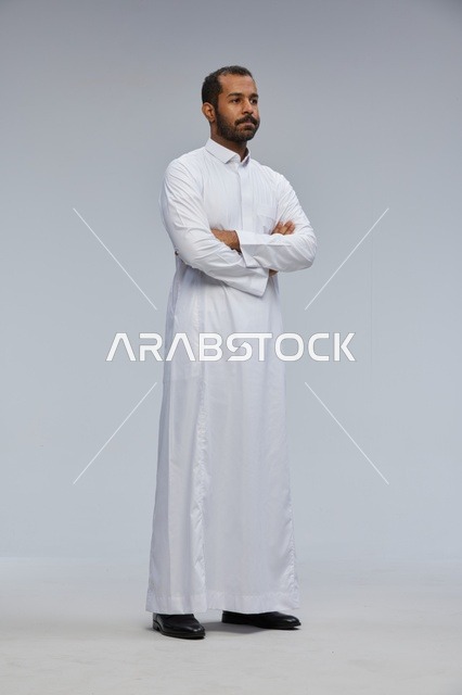 Saudi Man Wearing White Thobe Standing with Crossed Arms