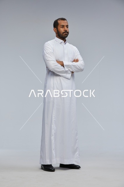 Saudi Man in White Thobe with Arms Crossed Studio Portrait