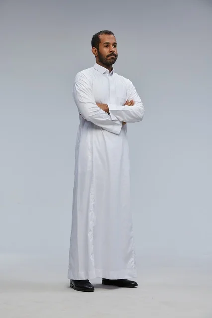 Saudi Man in White Thobe with Arms Crossed Studio Portrait