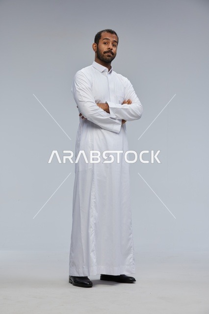 Saudi Man in White Thobe with Crossed Arms Full Portrait