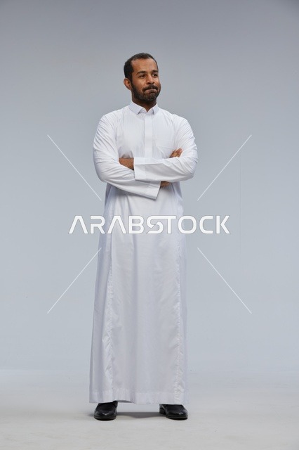 Saudi Man in White Thobe with Crossed Arms Studio Shot