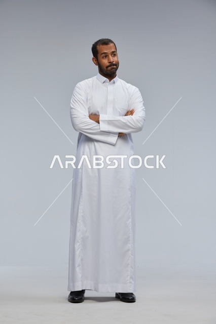 Saudi Man in White Thobe with Crossed Arms Portrait