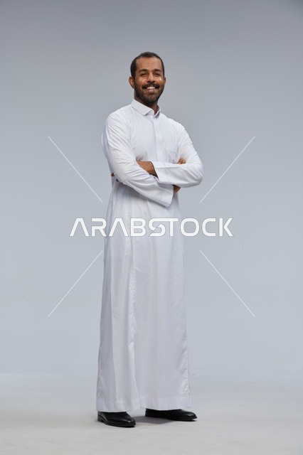 Saudi Man in White Thobe with Arms Crossed Standing