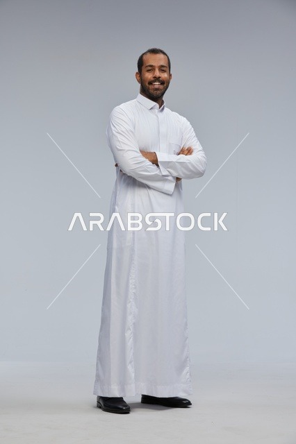 Saudi Man in White Thobe with Arms Crossed Studio Portrait