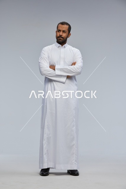 Saudi Man in White Thobe with Crossed Arms