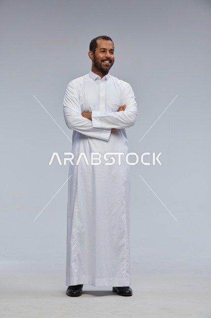 Saudi Man in White Thobe with Crossed Arms
