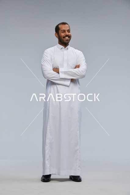 Saudi Man in Traditional White Thobe With Arms Crossed