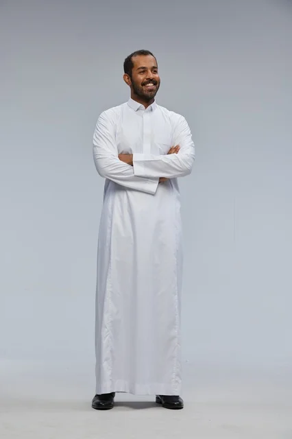 Saudi Man in Traditional White Thobe With Arms Crossed
