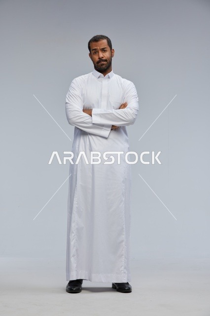 Saudi Man in White Thobe with Arms Crossed in Studio
