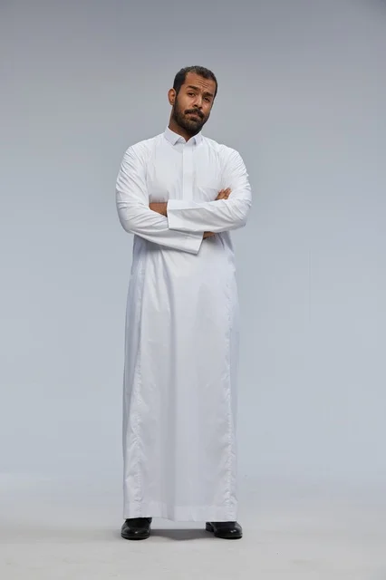 Saudi Man in White Thobe Standing in Studio Portrait