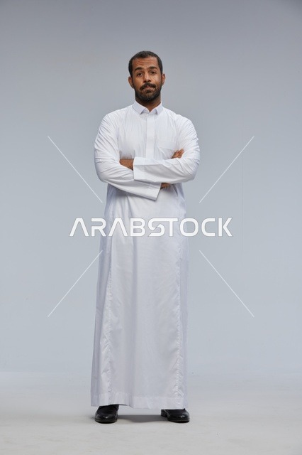 Saudi Man in White Thobe with Arms Crossed in Studio