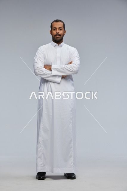 Saudi Man in White Thobe with Arms Crossed