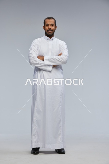 Saudi Man in White Thobe Standing with Arms Crossed