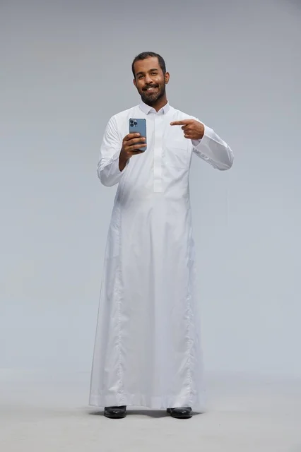 Saudi Man in White Thobe Pointing at Smartphone Studio