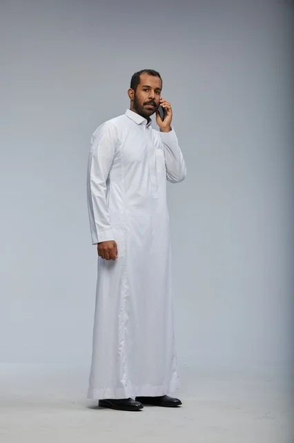 Saudi Man in White Thobe Talking on Smartphone in Studio