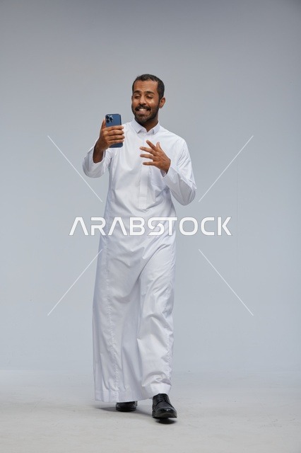 Saudi Man in White Thobe Taking Smartphone Selfie Studio