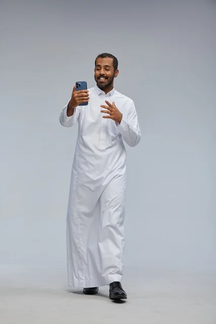 Saudi Man in White Thobe Taking Smartphone Selfie Studio