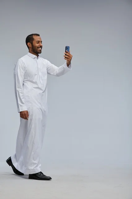 Saudi Man in White Thobe Taking Selfie in Studio