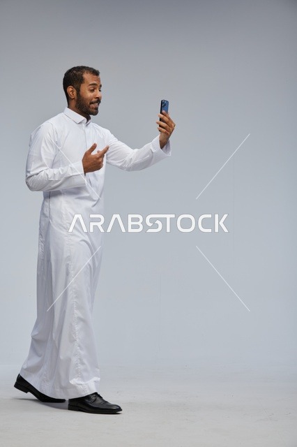 Saudi Man in White Thobe Taking Smartphone Selfie