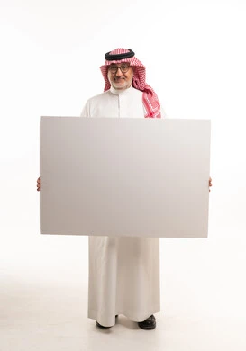 رجل سعودي يحمل لوحة فارغة على خلفية بيضاء