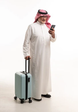 Elderly Saudi Man with Suitcase and Smartphone