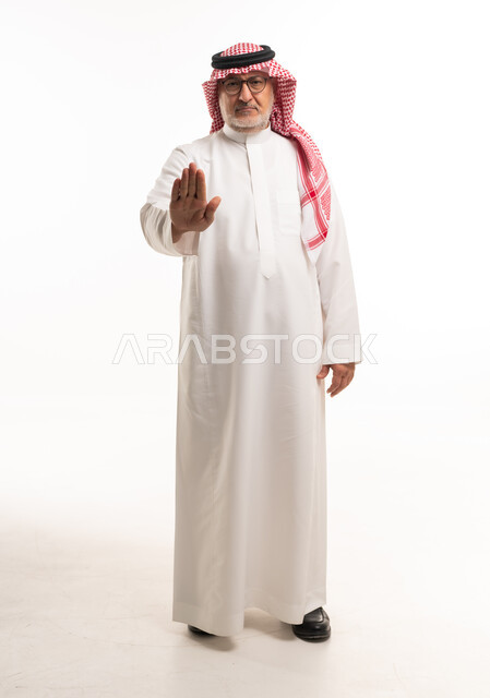 Senior Saudi Man Making Stop Gesture in Studio