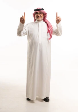 Elderly Saudi Man Pointing Upwards on White Background