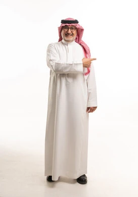 رجل سعودي يرتدي الثوب التقليدي يشير للجانب بخلفية بيضاء