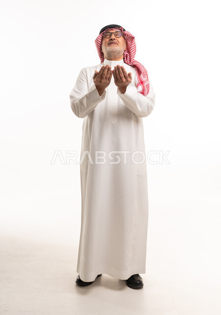 Saudi Man in Traditional Dress Praying on White Background