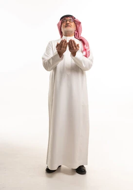 Saudi Man in Traditional Dress Praying on White Background
