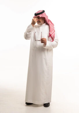 Senior Saudi Man with Headache in Traditional Dress