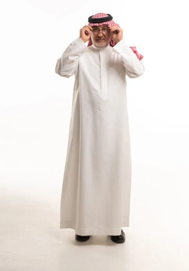 Mature Saudi Man in Traditional Thobe Adjusting Eyeglasses