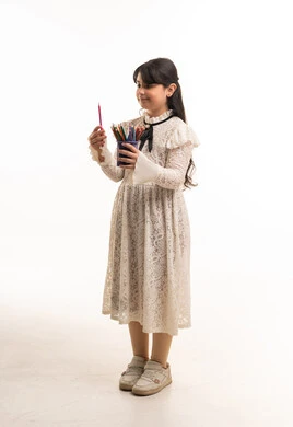 Saudi Girl in Lace Dress Holding Colored Pencils