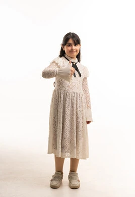 Saudi Girl in White Lace Dress Giving Thumbs Up