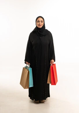 Emirati Woman in Black Abaya Holding Multiple Shopping Bags