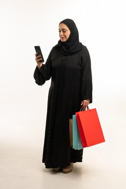 Saudi Woman with Shopping Bags and Smartphone