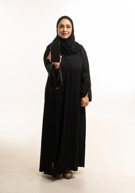 Arab Woman in Abaya Holding Smartphone on White Background