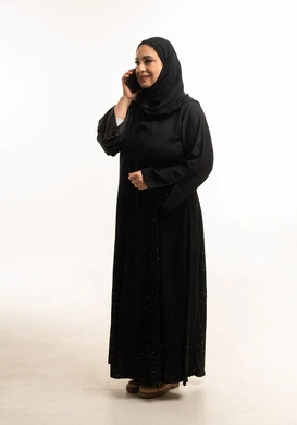 Saudi Woman in Black Abaya Talking on Smartphone