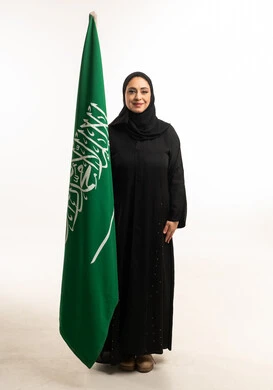 Saudi Woman in Abaya Standing with Saudi Arabia Flag