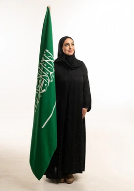 Saudi Woman Holding National Flag in Studio