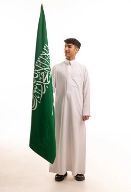 Saudi Man in White Thobe Holding Saudi National Flag