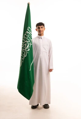 Saudi Man in Thobe Holding National Flag in Studio