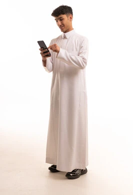 Young Saudi Man in White Thobe Using Smartphone Studio
