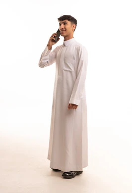 Saudi Man in White Thobe Using Smartphone Studio Shot