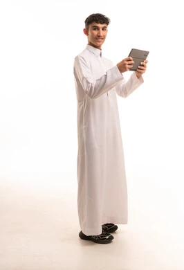 Saudi Male in White Thobe Holding Digital Tablet