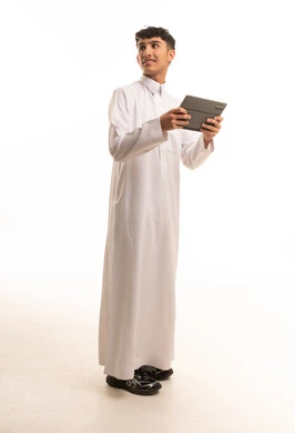 Saudi Man in White Thobe Holding Digital Tablet